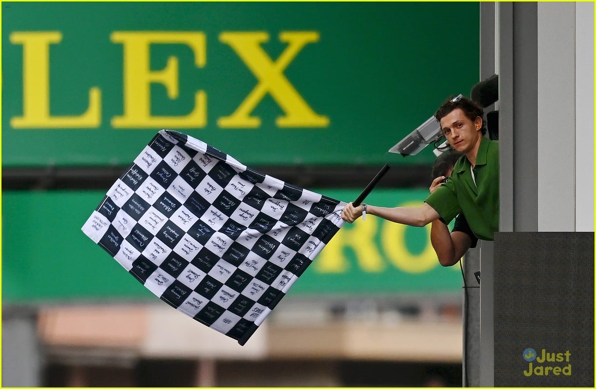 tom holland waves checkered flag at f1 monaco grand prix 04
