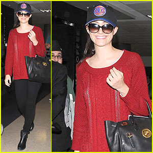 Emmy Rossum Flashes a Smile Under Claustrophobic & Sweaty Conditions at LAX Airport
