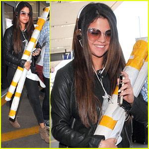 Selena Gomez Carries Two Large Rolls At LAX