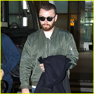Sam Smith Is Welcomed With Hugs Upon London Landing